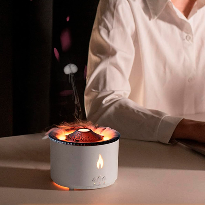 The diffuser is designed in the shape of a volcano, emitting a haze and glowing in a pleasant orange or blue light.